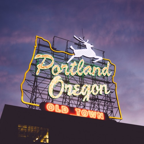 large neon sign featuring th outline of the state of Oregon with the text 'Portland Oregon Old Town' and a leaping deer