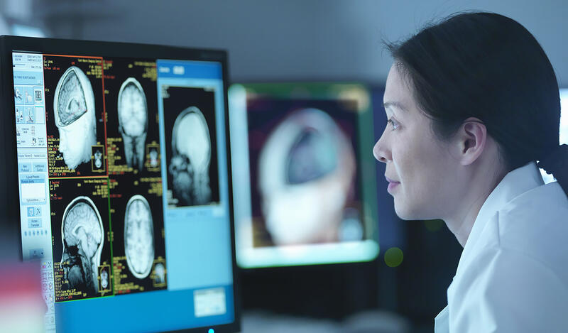 A woman studying a medical image