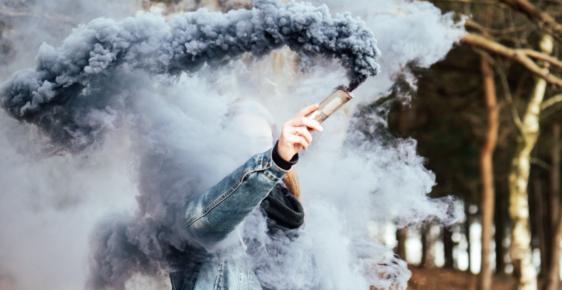 person creating smoke with handheld device