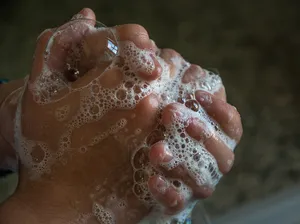 A pair of hands covered in soap bubbles