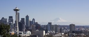 View of Seattle, including the Space Needle to the left and Mount Rainier in the distance.